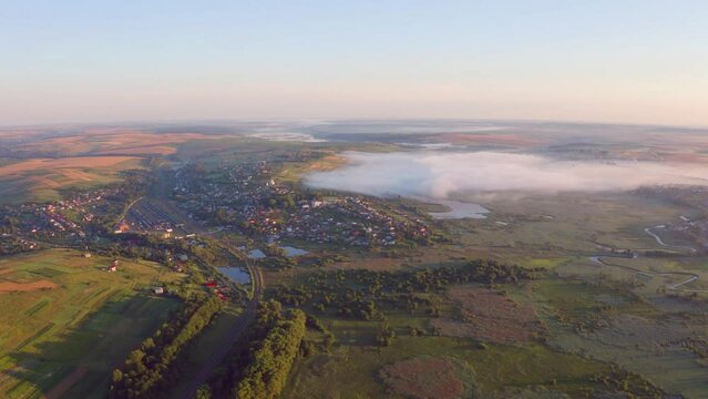 4k drone flying over footage (Ultra High Definition) of zigzag shape Seret river. Captivating sunrise on Ternopil countryside, Ukraine, Europe. Traveling concept background.