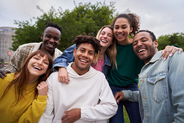 Multiracial group of friends outdoors smiling and having fun. International students happy together...