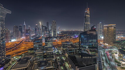 Fototapeta na wymiar Panorama showing futuristic Dubai Downtown and finansial district skyline aerial night timelapse.