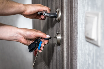 Locking up or unlocking entrance door with key in hand