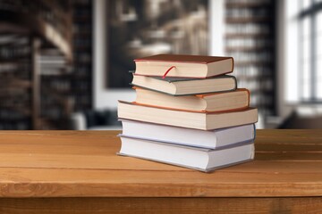 Stacks of old reading books on desk in library.