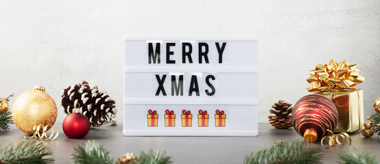 Lightbox with text Merry xmas and christmas decor on the table against white background