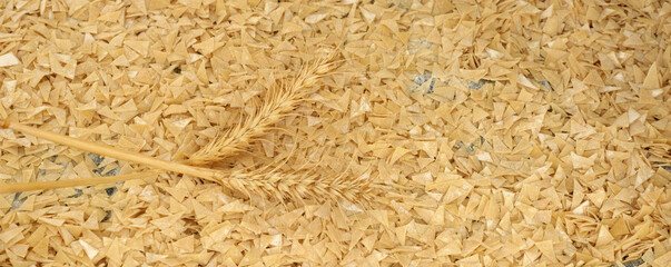 Close-up of homemade natural dough noodles, triangular dough and wheat ears on it to make dough soup specific to Turkey,