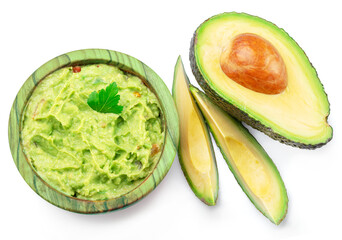 Guacamole and cross section of avocado fruit isolated on white background.
