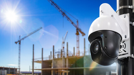 CCTV camera at construction site. Dome camera near house under construction. Ensuring safety of...