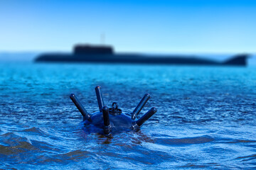 Sea mine floats in water. Anti-ship bomb to destroy sea vessel. Submarine floats near sea mine....