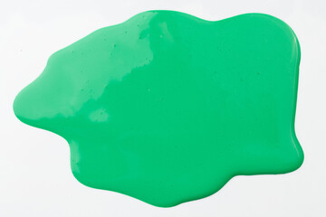 Acrylic paint blot, chaotic brushstroke, spot flowing on white paper background. Creative green color backdrop, fluid art.