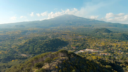Nicolosi, Sicily, Italy. Volcanic craters overgrown with forest on the slopes of Mount Etna, Aerial...