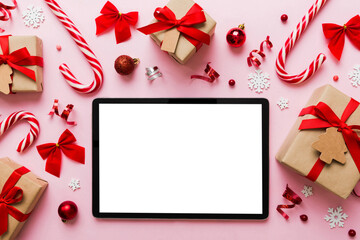 Top view of empty tablet on Christmas background made of new year decorand festive decorations. New year holiday concept. Mockup