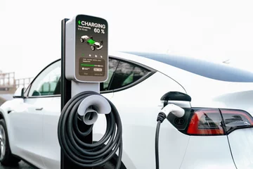 Zelfklevend Fotobehang Electric car recharging battery at outdoor EV charging station for road trip or car traveling, alternative and sustainable energy technology for eco-friendly car. Perpetual © Blue Planet Studio
