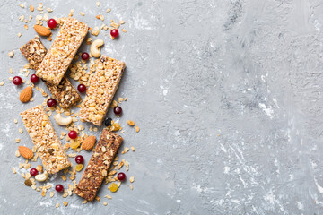 Various granola bars on table background. Cereal granola bars. Superfood breakfast bars with oats, nuts and berries, close up. Superfood concept
