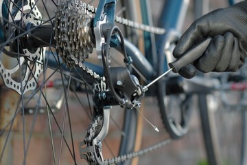 Bicycle maintenance. The owner of the bicycle conducts an inspection of the technical condition,...