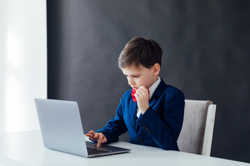 online learning boy at the computer in the classroom