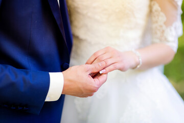 A close up of a person putting a wedding ring on another person's finger. A Tender Moment:...