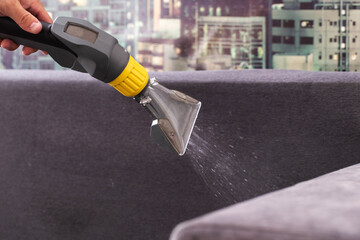 Applying a special cleaning solution to clean stains and dirt on upholstery of upholstered...
