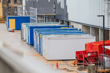 Shipping containers for construction sites in white and blue colors at construction site