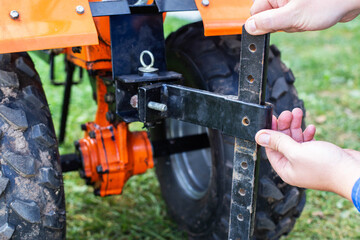 Adjustment of the coupling and attachments in a multifunctional motor cultivator for cottages....