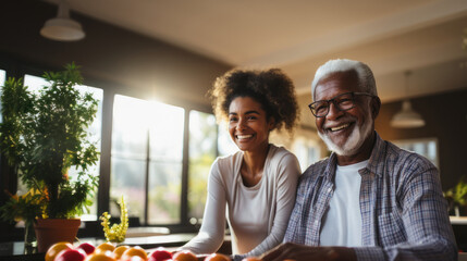 Portrait of smiling senior african american couple looking at camera in kitchen at home.
