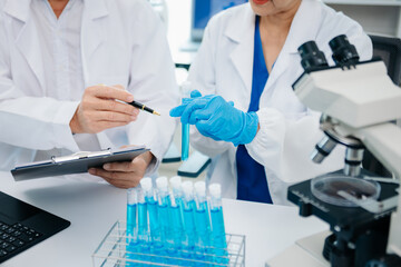 Fototapeta premium Scientist two woman with tablet and laptop, laboratory and ecofriendly science. Agriculture, research and scientists with online reading, test samples