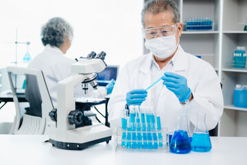 scientists conducting research investigations in a medical laboratory, a researcher in the foreground is using a microscope in laboratory for medicine.  ..