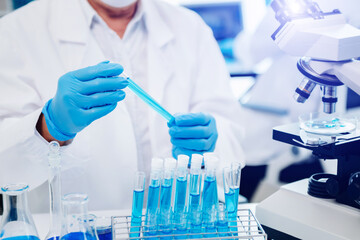 Fototapeta premium scientists conducting research investigations in a medical laboratory, a researcher in the foreground is using a microscope in laboratory for medicine. ..