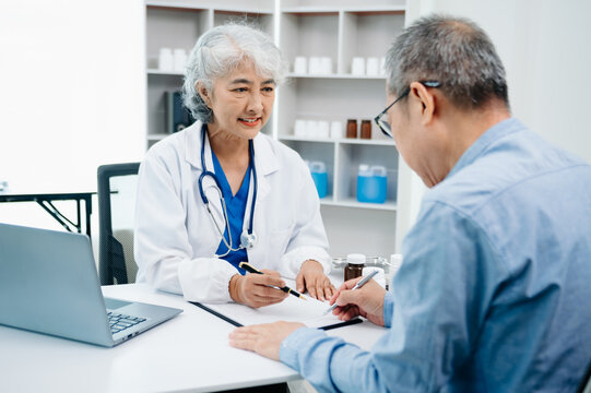 A professional physician talks to discuss results or symptoms and gives a recommendation to a male patient and signs a medical paper