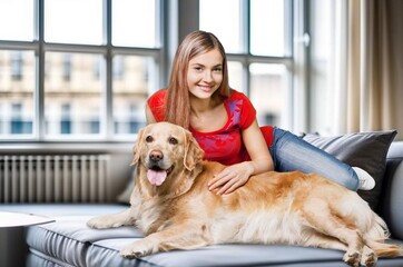 Happy cheerful young woman hugging pet dog