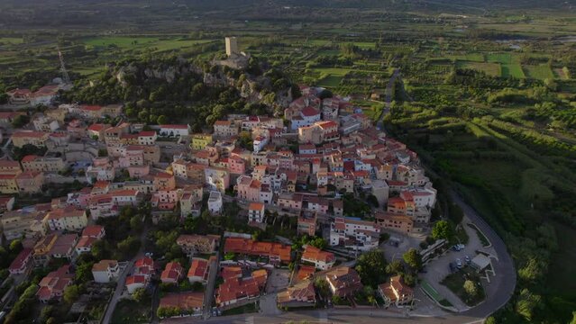 Fantastic aerial view in orbit over the town of Posada on the island of Sardinia during sunset.