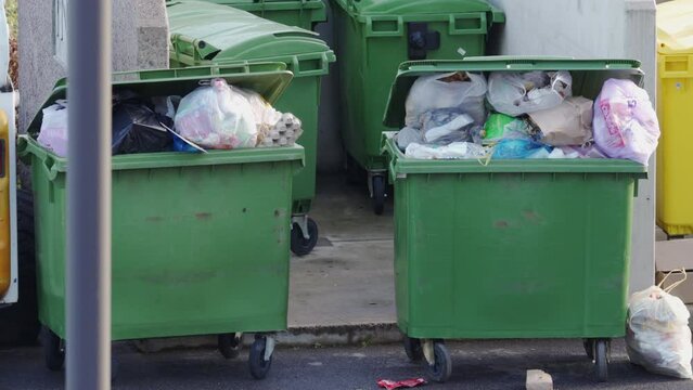 Outdoor overfilled garbage cans for storage and collection of waste in residential apartment complex