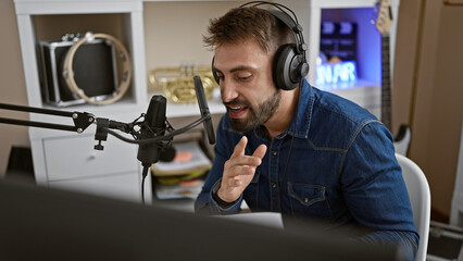 Passionate young hispanic man, an emerging music artist, unleashes melody in a pro music studio, singing his heart out, headphones on, lost in his musical world, perfecting his song performance