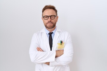Middle age doctor man with beard wearing white coat skeptic and nervous, disapproving expression on...