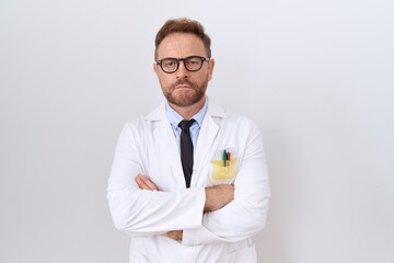 Middle age doctor man with beard wearing white coat skeptic and nervous, disapproving expression on...