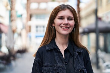 Young blonde woman smiling confident standing at street