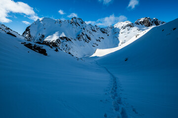 Fototapeta na wymiar Snowshoe tracks in a winter mountain landscape
