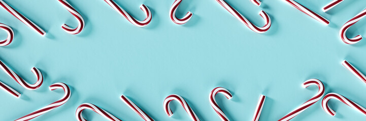 Christmas lollipop or candy cane with copy space on blue background. 3D Rendering, 3D Illustration