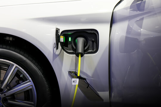 Power cable pump plug in charging power to electric vehicle EV car.