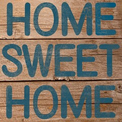 Home sweet home sign, on a natural wooden background. Bold sign for a new home or for an old well loved home. Turquoise text on a rustic shabby chic plank background.