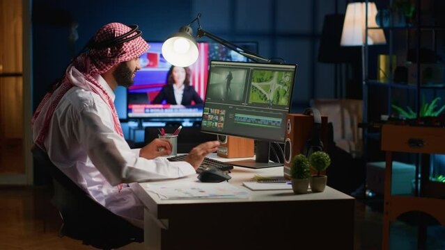 Cinematographer in home office doing post production on upcoming movie release, editing footage and sound. Man using computer workstation after being comissioned to modify film