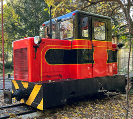 Little red and black train engine in the amusement park
