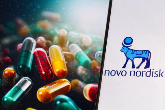 Novo Nordisk logo on phone screen, drug pills in the background, Warsaw, Poland - November 13, 2023