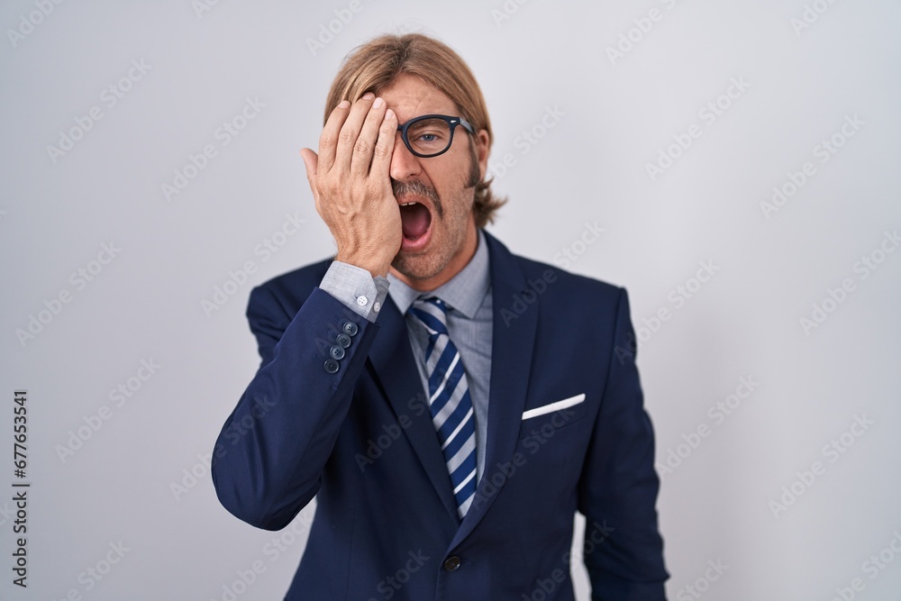 Poster caucasian man with mustache wearing business clothes yawning tired covering half face, eye and mouth