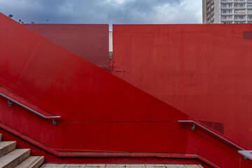 Ivry-Sur-Seine, France - 09 20 2021: View of a graphic red wall and staircase with steps and ramp in the city. - Powered by Adobe