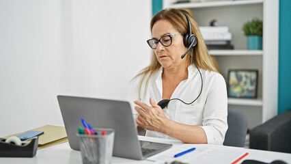 Middle age hispanic woman business worker having video call at the office