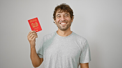 Beaming young man joyfully presents his pass, a singapore passport, confidently standing isolated...