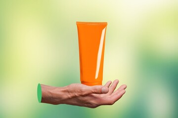 woman hand holding a blank tube