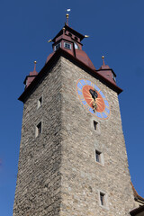 Fototapeta na wymiar Clock tower near baroque church, switzerland, lucerne