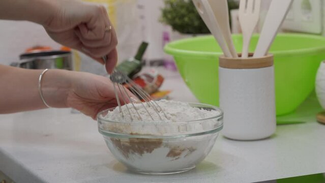 woman mixing ingredients in bowl to bake Christmas gingerbread cookies