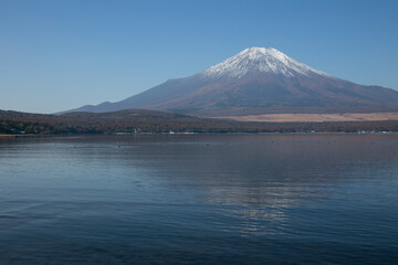 Views  of Mount Fuji covered in snow from Yamanaka lake in Yamanakako, Japan.