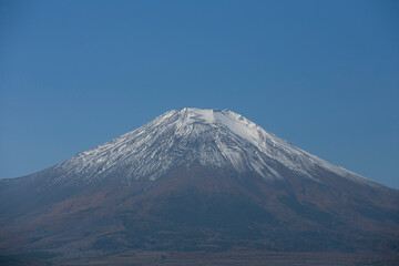 Views  of Mount Fuji covered in snow from Yamanaka lake in Yamanakako, Japan.