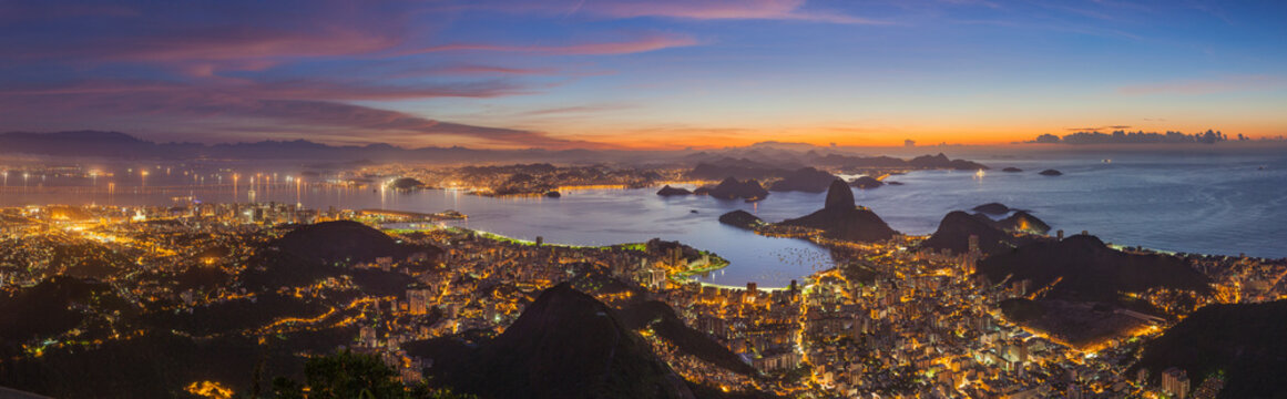 Panoramic view of Rio de Janeiro at sunset, view of the Pao de Acucar (Sugar Loaf Mountain) and Botafogo bay, Brazil.